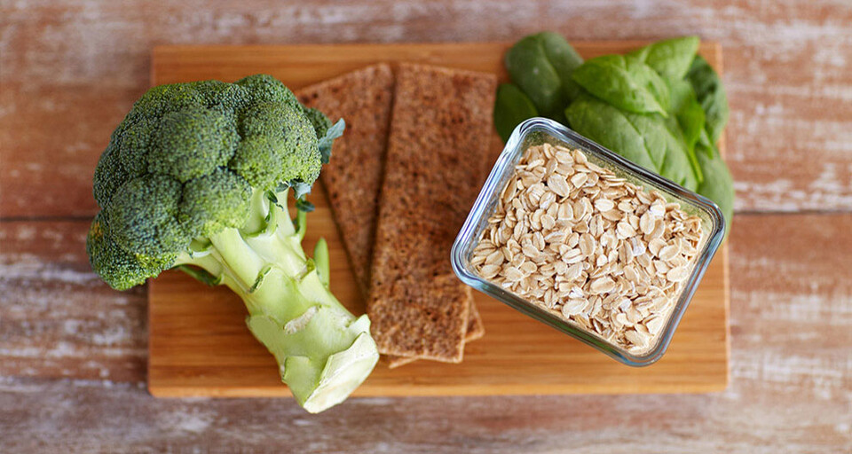 Brocoli with other healthy dishes on a cutting board.