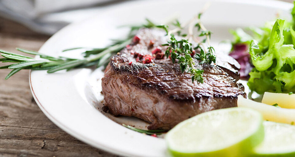 A meal composed steak and salad that provides the necessary iron and nutrients.