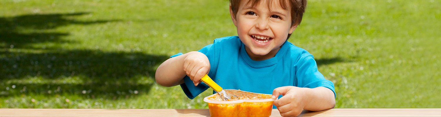A young boy enjoying his HIPP baby food meal.